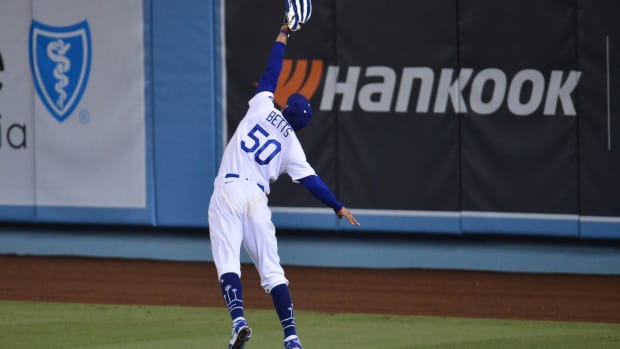 Sep 22, 2020; Los Angeles, California, USA; Los Angeles Dodgers right fielder Mookie Betts (50) catches a hit off Oakland Athletics right fielder Stephen Piscotty (25) during the ninth inning at Dodger Stadium. Mandatory Credit: Gary A. Vasquez-USA TODAY Sports